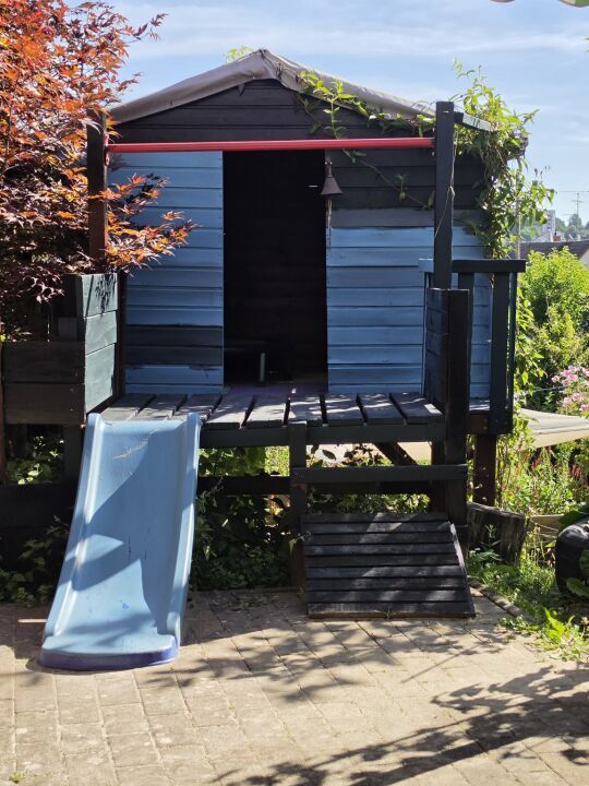 Spielhaus mit Rutsche im Garten