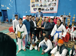 Punjab players receiving Poomsae Team Trophy at 39th open National Taekwondo Championship K D Singh babu Stadium Punjab players with Grandmaster Er. Satpal Singh Rehal receiving Poomsae Team Trophy from Grandmaster Jimmy R. Jagtiani at 39th open National Taekwondo Championship K D Singh babu Stadium